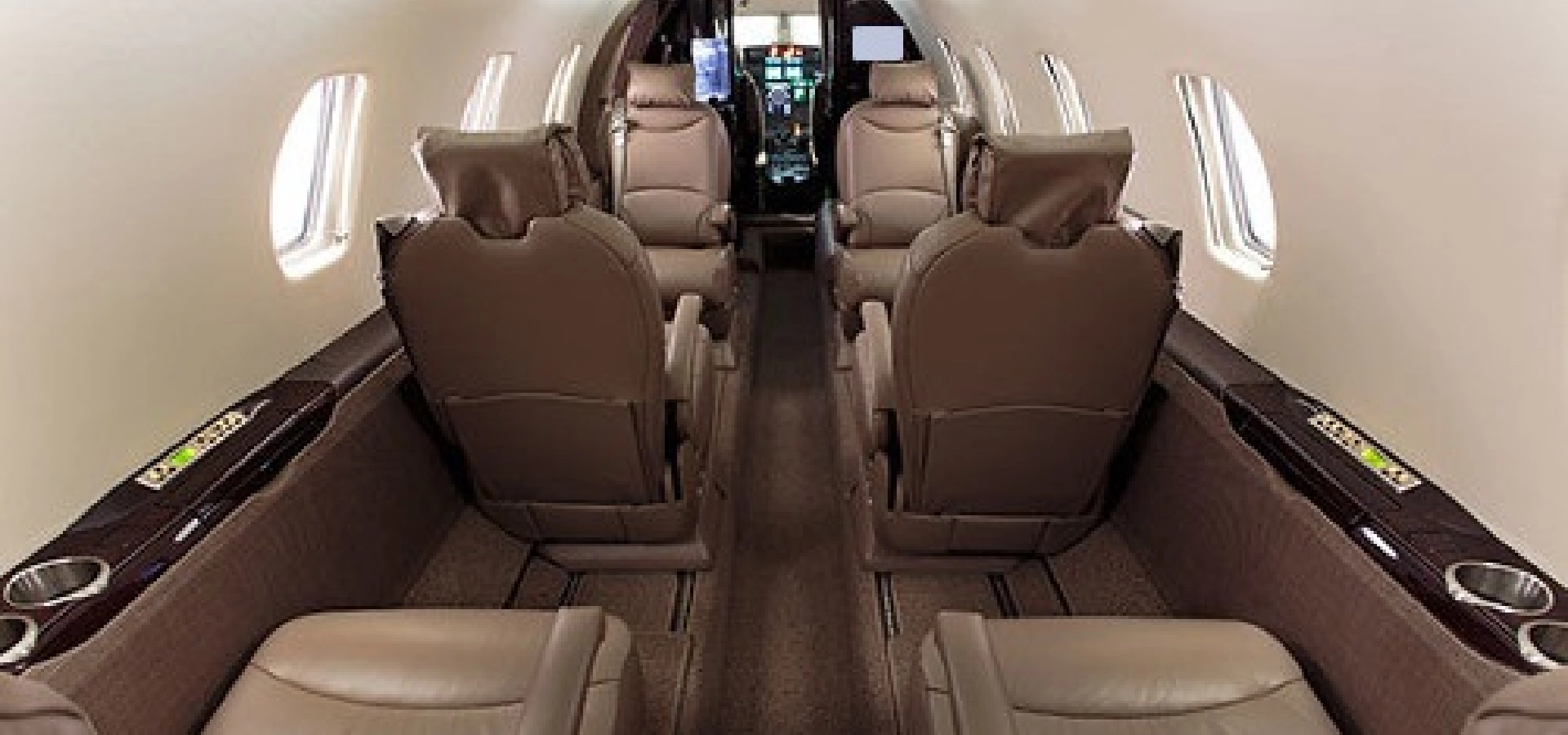 Experience the luxury of business jets for sale with an interior featuring six brown leather seats, windows on both sides, and a sweeping view of the cockpit at the front. Perfect for those considering aircraft acquisition and seeking top-notch aviation consulting services.