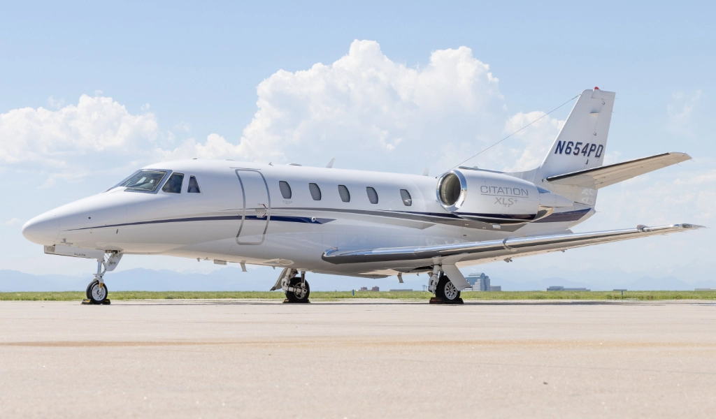 A luxury jet poised elegantly on the runway, framed by clear skies and distant mountains, offers a tantalizing glimpse into the world of private jets for sale.