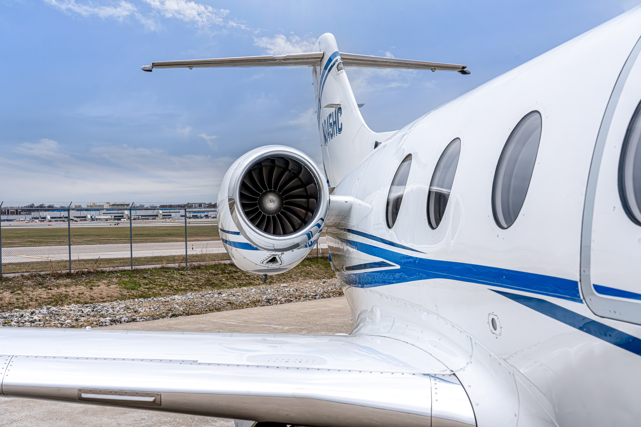 A small private jet, perfect for those exploring business jets for sale, is parked on an airport tarmac.