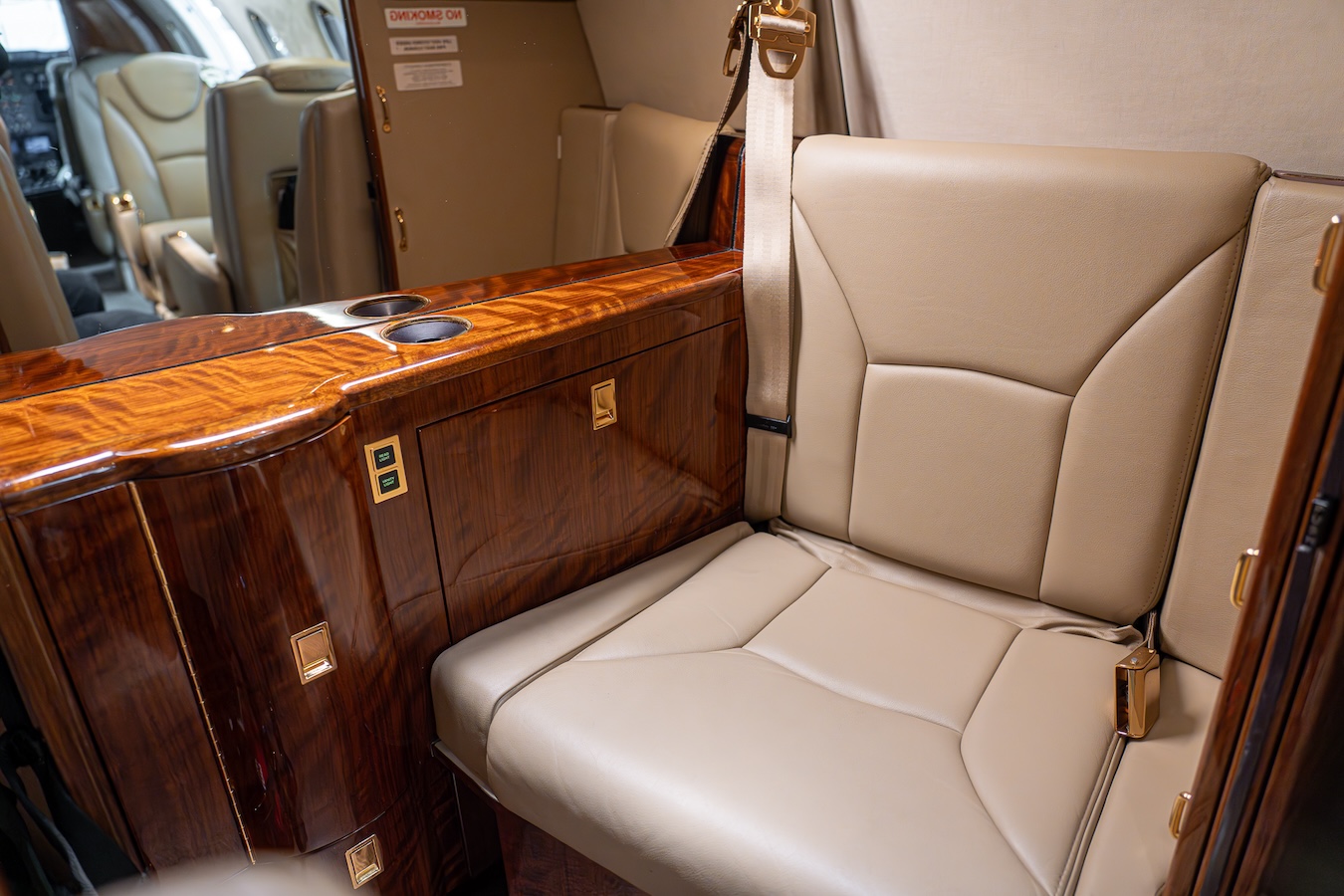 The interior of a private jet exudes elegance with beige leather seats.